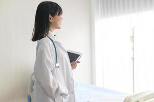 Portrait of young female doctor with stethoscope working at hospital, medical and health care concept photo