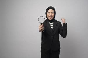 Muslim business woman holding Magnifier isolated on white background photo