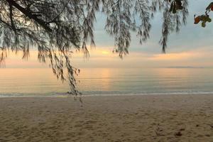 Beautiful sand beach background with soft wave in the morning. photo