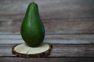 organic avocado on a wooden board photo