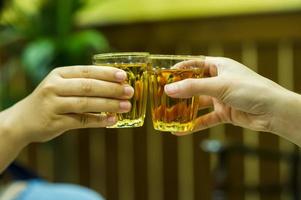 Hand and liquor juices in the liquor store drinking liquor. The concept of drinking and intoxication photo