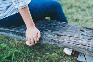 Young girl alone On the wood alone In public areas In good weather Cool wind, most comfortable vacation ideas. photo