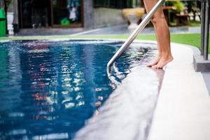 Girl standing by the pool. Ready to swim To swim alone Swimming ideas for exercise And play for fun. photo