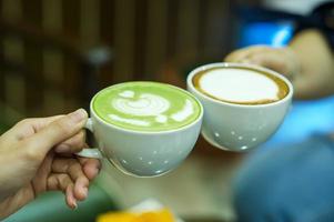 Hand and coffee and hot green tea Young people love to drink hot drinks. Healthy Coffee Food and Drink Concepts photo