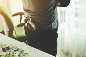 Money and hands of a young businessman. Success in the business. And his money. Put on the desk photo