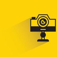 digital camera on stand yellow background vector