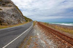 Empty road and railway track in New Zealand photo