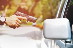 9mm automatic pistol holding in right hand of shooter, concept for security, robbery, gangster, bodyguard around the world. selective focus on pistol. photo