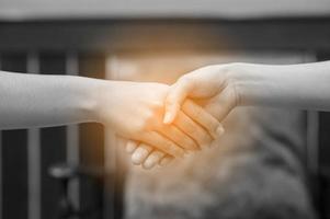 Join the hands of two people. And the greeting of friends. Communicate in team and teamwork. Teamwork concept photo