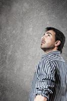 Portrait of expectant man looking up. Vertical photo