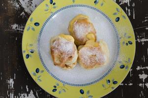 Top view of fried fritters sifted by sugar powder photo