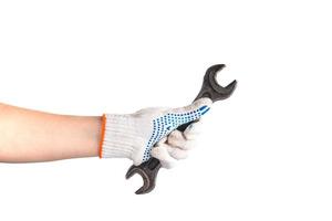 Man in white work gloves holds wrench. photo