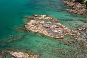 Aerial view Top down seashore rocks sea surface in sunny day Good weather day summer background photo