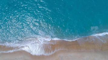 Aerial view sandy beach and waves Beautiful tropical sea in the morning summer season image by Aerial view drone shot, high angle view Top down photo