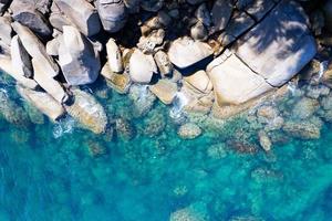 Aerial view Top down seashore rocks sea surface in sunny day Good weather day summer background photo