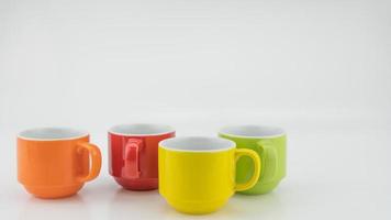 Colorful coffee cup on colorful paper background A lot of cups for coffee and tea in coffee shop Food and drink background concept photo