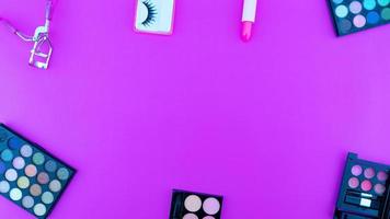 Set of eyeshadow and blush isolated on colorful paper background photo