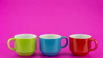 Colorful coffee cup on colorful paper background A lot of cups for coffee and tea in coffee shop Food and drink background concept photo