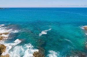 Aerial view Top down seashore wave crashing on seashore Beautiful turquoise sea surface in sunny day Good weather day summer background Amazing seascape photo