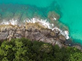 Aerial view Top down seashore Beautiful turquoise sea and mountain in sunny day Good weather day summer background Amazing sea in Phuket Thailand on November 23-2021 photo