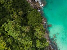 Aerial view Top down seashore Beautiful turquoise sea and mountain in sunny day Good weather day summer background Amazing sea in Phuket Thailand on November 23-2021 photo