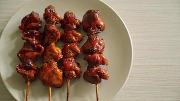 grilled chicken gizzard skewer with herbs and spices on plate video