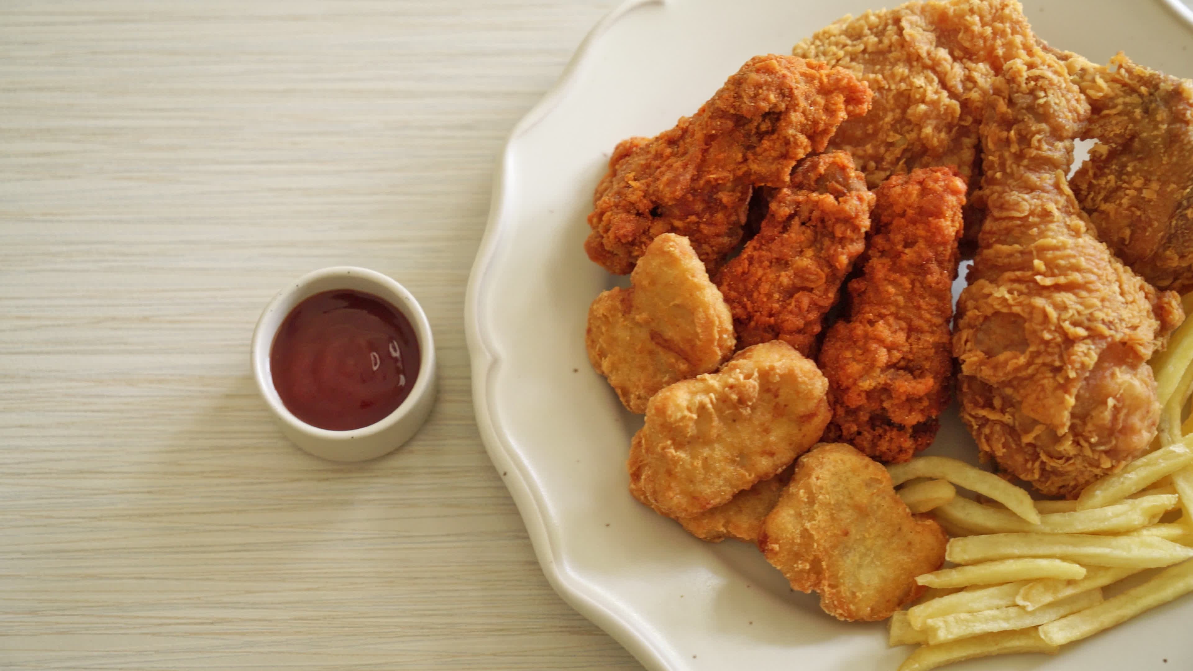 fried chicken with french fries and nuggets on plate unhealthy food