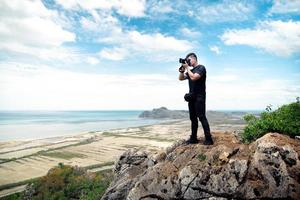 Man photographer traveling and photographing mountains photo