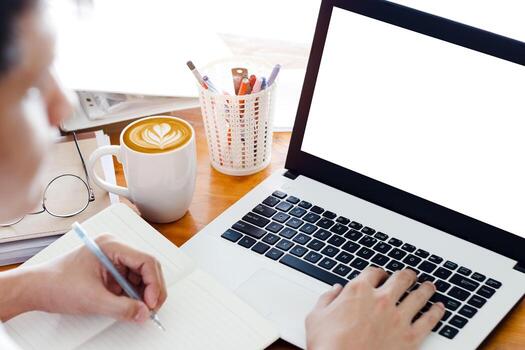 Mockup Copy Space Computer Notebook Laptop Concept, a man's hand using a laptop on internet websites at the office, keyboards on laptop computer with balnk copy screen for your advertising content. photo