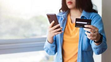 Asian Woman hand using mobile smart phone, online payment, banking and online shopping at the office. photo