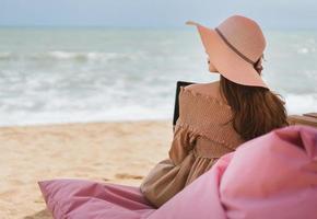 Woman relax from working at the beach in holidays photo