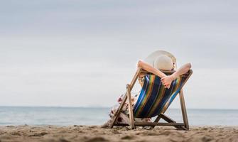 Asia woman relax on beach chair at Pattaya, Thailand photo