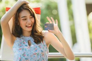 Asian young woman shopping pay with credit card. photo