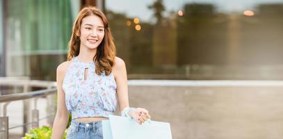 Asian smile woman with shoppping bags banner copy sapce photo
