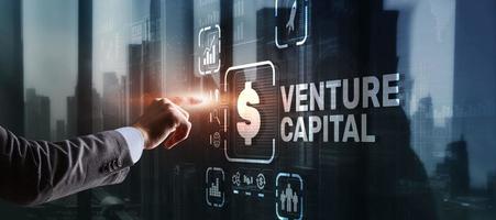 Venture capital. Investor capital. Businessman pressing virtual screen inscription photo