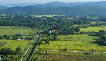 High panorama view of lush green fields and mountains on background. North Thailand rural. photo
