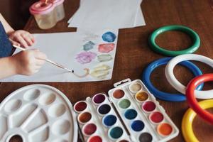 Top view of hands and brush paint watercolor  gouache photo