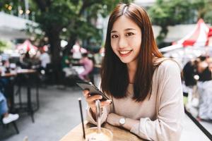 Portrait of young adult business asian woman with modern gadget technology on day. photo
