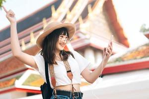 Hipster young asian energetic glasses girl modern style. Listen stream music with smart phone application. photo