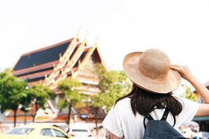 Back view of asian young woman traveller at temple Wat pho famous destination landmark. photo