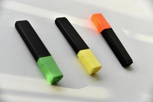 Colored markers on a white background in the light photo