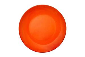 An empty large round ceramic plate of bright orange color for food on a white isolated background is photographed from the top view. Concept layout for labeling and food placement. Mockup. Flat lay.