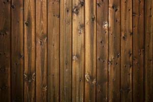 Dark textured wooden background made of brown boards. Old rustic vertical boards. The concept is ecology, vintage, village, nature. Flat lay. Space for text. photo