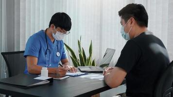 Doctors are explaining the treatment of a patient's illness while wearing a mask during the epidemic. photo