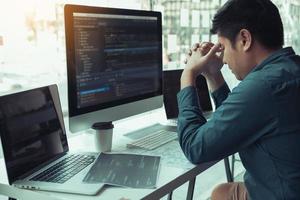 Software developers headache with code analysis in the office. photo