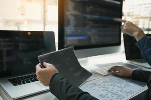 Two software developers are analyzing together about the code written into the program on the computer. photo
