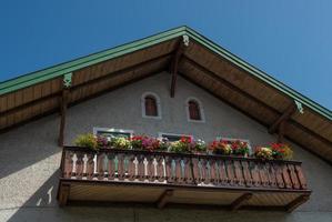 Flowers on wooden balcony photo