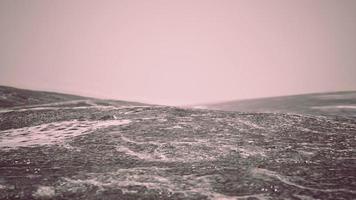 foggy mountain landscape with snow cornice over abyss inside cloud photo