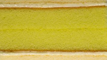 Sponge cake texture. Layer cake, center green pandan leaves and cream, topped with vanilla flavor. photo