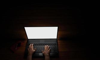 The hand of a person using a notebook or laptop, a blank screen, white, dark background, blacklight shines down on the hand. Mystery operation or hacker.3D Rendering photo